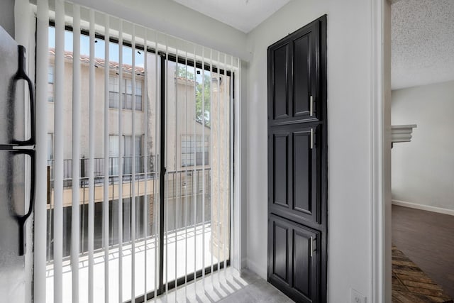 foyer with hardwood / wood-style floors and a textured ceiling