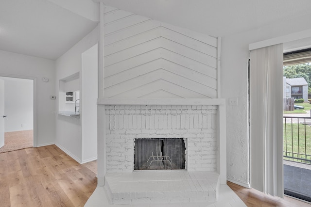 room details featuring hardwood / wood-style flooring and a brick fireplace