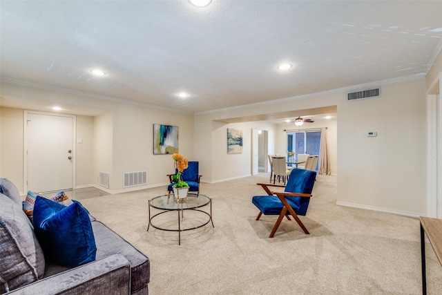 carpeted living room featuring crown molding and ceiling fan