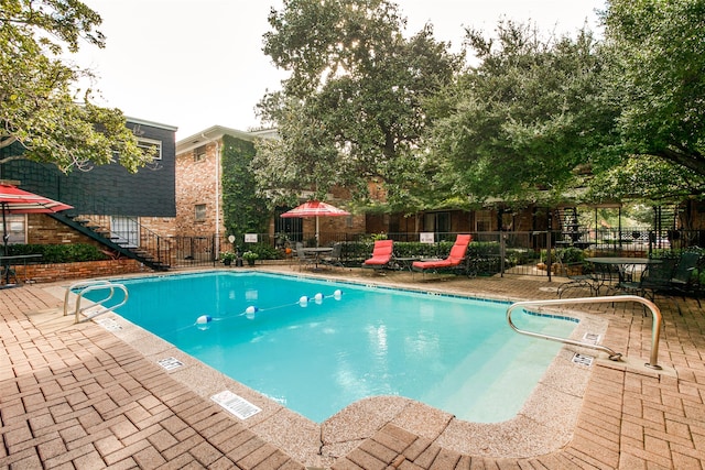 view of swimming pool featuring a patio area