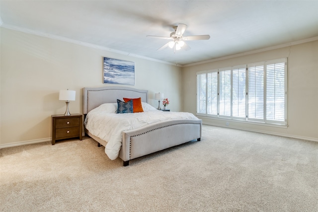 carpeted bedroom with ceiling fan and ornamental molding