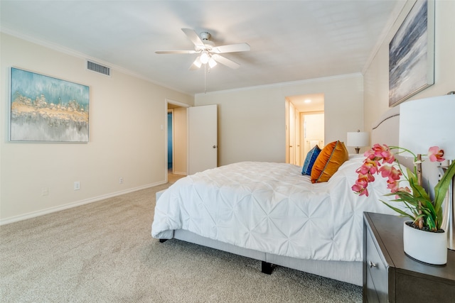 carpeted bedroom with ceiling fan and crown molding