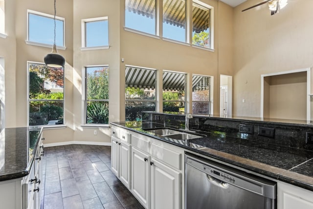 kitchen with dishwasher, white cabinets, and plenty of natural light