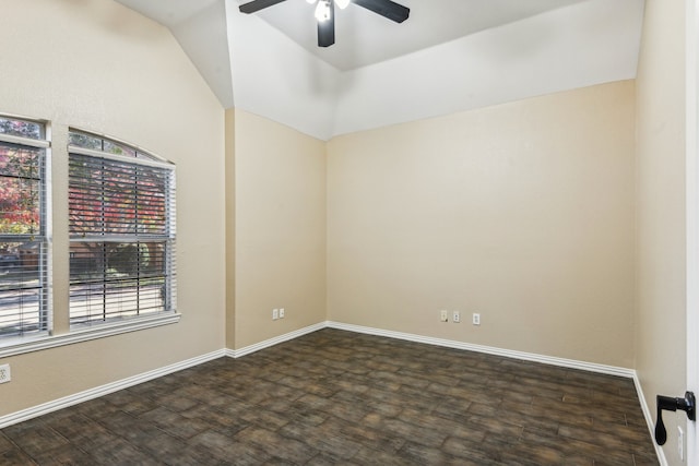 spare room featuring dark wood-type flooring, ceiling fan, and lofted ceiling