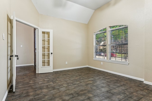 empty room with french doors, dark hardwood / wood-style floors, and vaulted ceiling