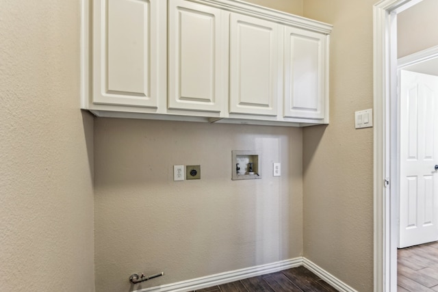 clothes washing area featuring electric dryer hookup, cabinets, dark wood-type flooring, and hookup for a washing machine