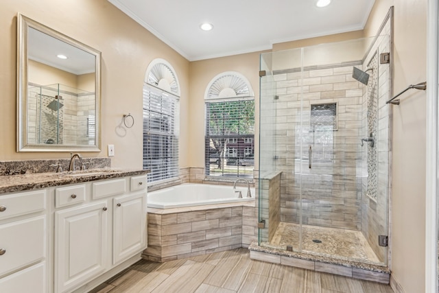 bathroom featuring vanity, shower with separate bathtub, and crown molding