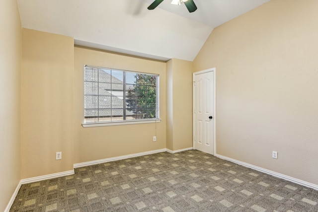 carpeted empty room featuring ceiling fan and lofted ceiling