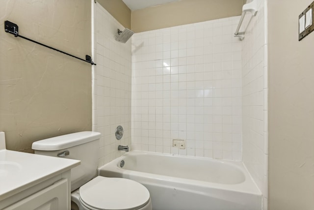 full bathroom with toilet, vanity, and tiled shower / bath