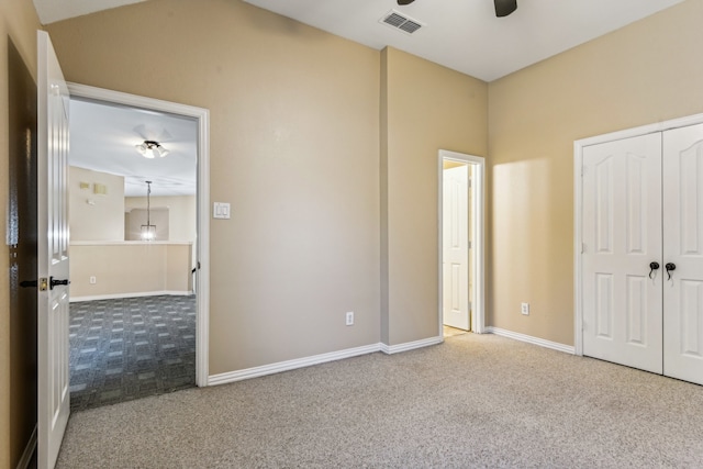 unfurnished bedroom featuring ceiling fan, carpet floors, and a closet