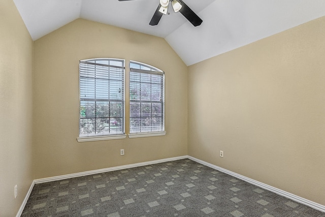 unfurnished room featuring dark carpet, ceiling fan, and lofted ceiling