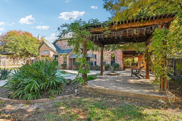 view of yard featuring a fenced in pool, a patio area, and ceiling fan