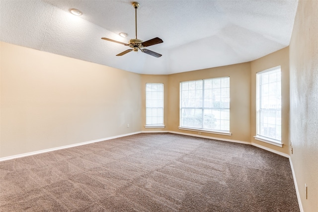 carpeted spare room with ceiling fan and a textured ceiling