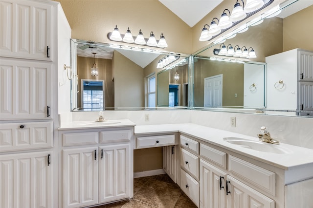 bathroom with tile patterned flooring, vanity, and vaulted ceiling