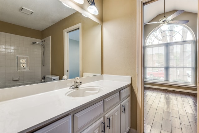 bathroom with ceiling fan, plenty of natural light, wood-type flooring, and toilet