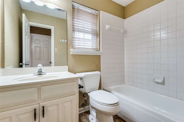 full bathroom featuring vanity, toilet, and tiled shower / bath