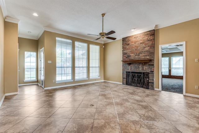 unfurnished living room featuring crown molding, ceiling fan, plenty of natural light, and a brick fireplace