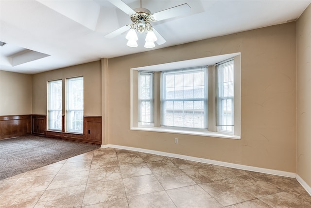 empty room featuring ceiling fan, a healthy amount of sunlight, and light colored carpet