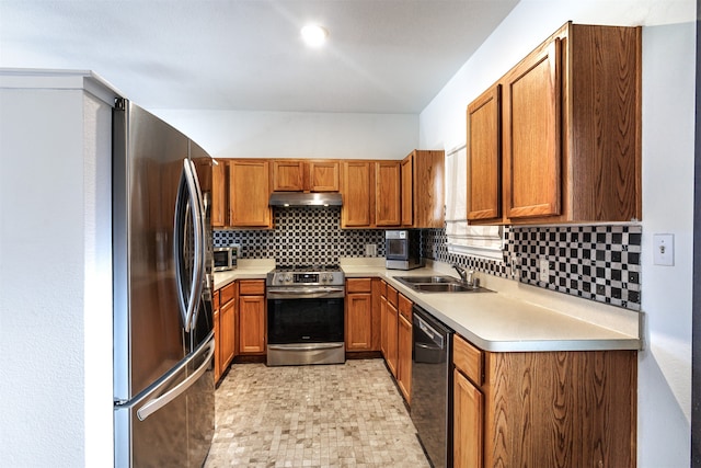 kitchen featuring sink, stainless steel appliances, and tasteful backsplash