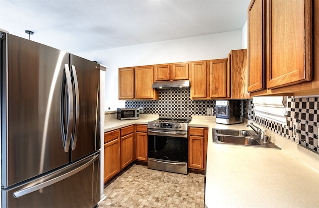 kitchen featuring decorative backsplash, sink, and appliances with stainless steel finishes