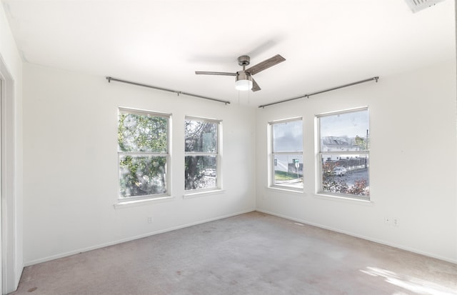 empty room featuring light carpet and ceiling fan