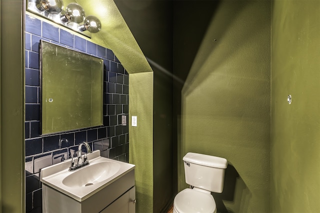 bathroom featuring decorative backsplash, vanity, and toilet