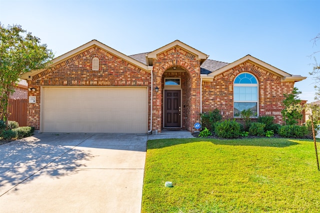 view of front of property featuring a garage and a front lawn