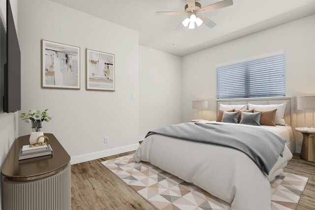 bedroom with light hardwood / wood-style flooring and ceiling fan