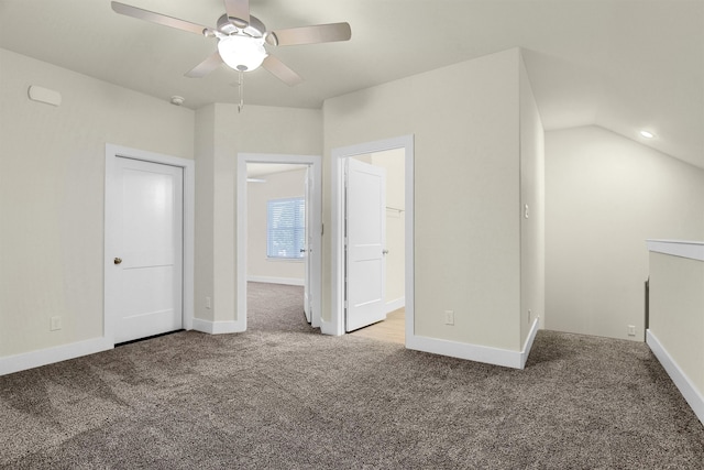 unfurnished bedroom featuring carpet flooring, ceiling fan, a closet, and vaulted ceiling