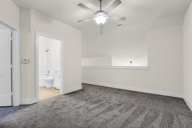 unfurnished bedroom featuring carpet flooring, connected bathroom, and ceiling fan