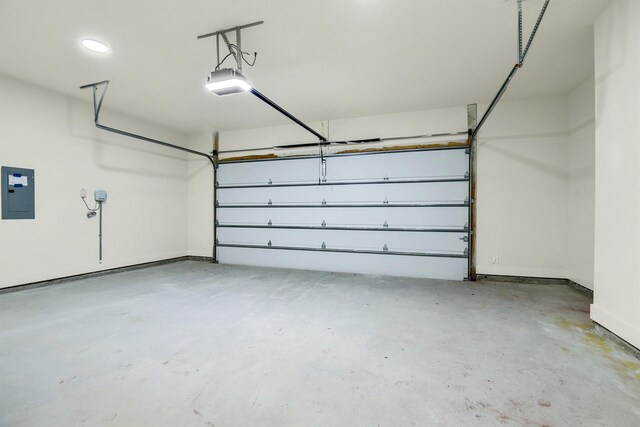 garage with electric panel and a garage door opener