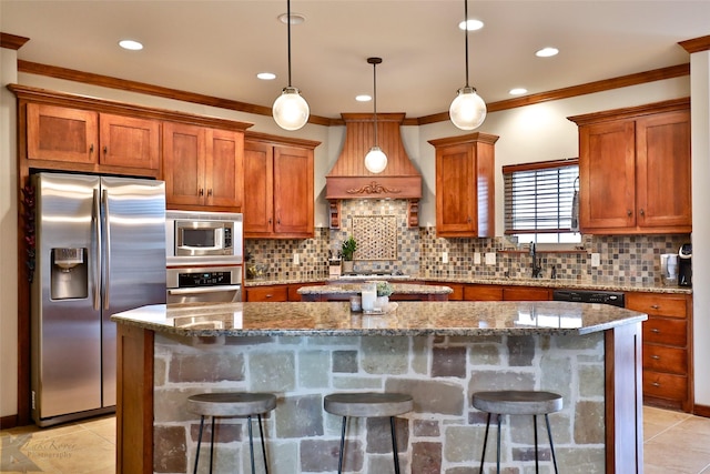 kitchen featuring a kitchen breakfast bar, a kitchen island, and appliances with stainless steel finishes