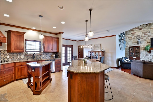 kitchen with light stone counters, crown molding, decorative light fixtures, dishwasher, and a center island