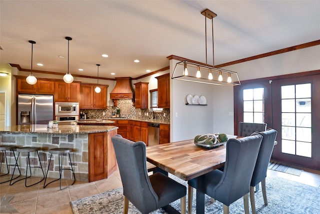 tiled dining room featuring crown molding