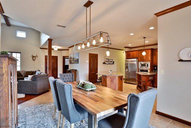 dining area featuring light tile patterned floors and ornamental molding