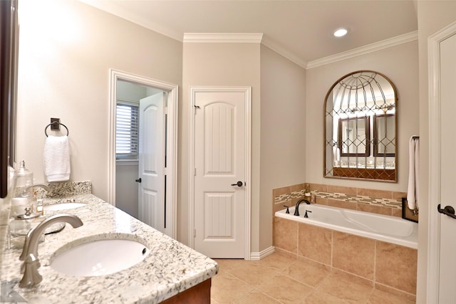 bathroom featuring tiled bath, crown molding, tile patterned flooring, and vanity