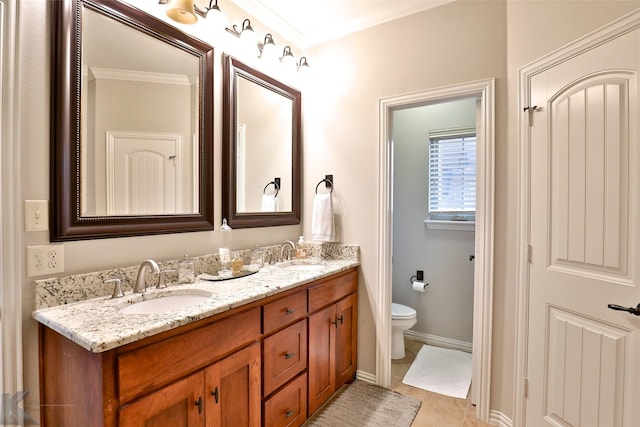 bathroom featuring tile patterned floors, vanity, toilet, and crown molding