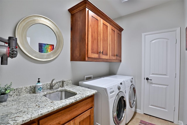 laundry area featuring washer and dryer, sink, light tile patterned floors, and cabinets