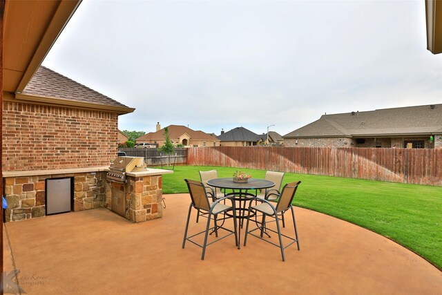 view of patio / terrace with area for grilling and a grill