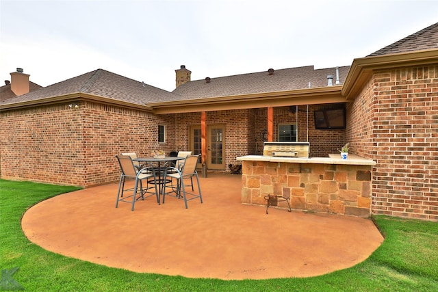 view of patio featuring a bar and exterior kitchen