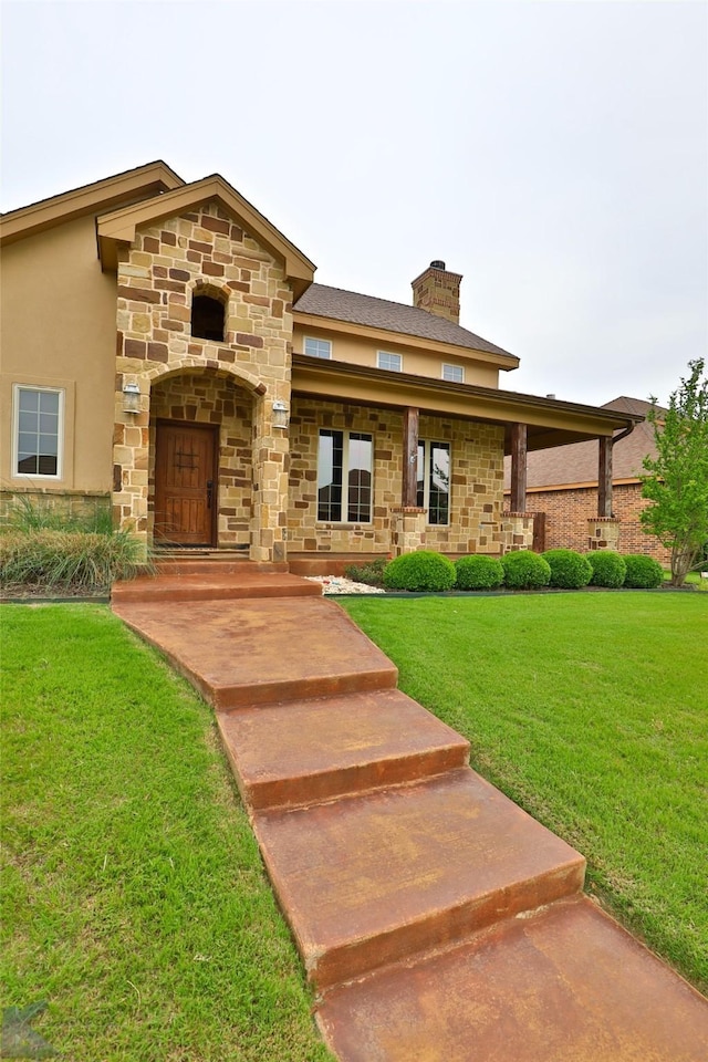 view of front of house with a front lawn and covered porch