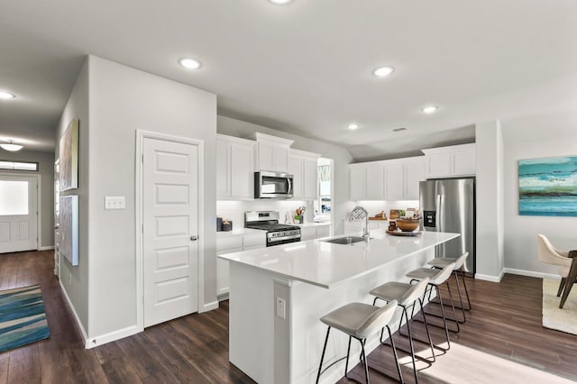 1914 Starling St, Princeton, TX 75407 - kitchen featuring sink, a center island with sink, a kitchen breakfast bar, stainless steel appliances, and white cabinets