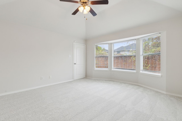 carpeted spare room featuring ceiling fan and lofted ceiling