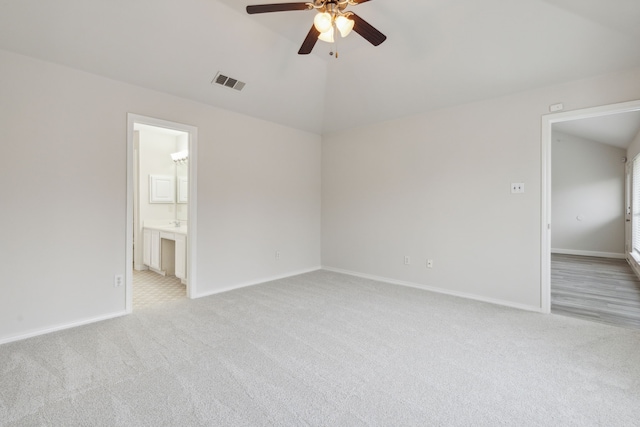 spare room with ceiling fan and light colored carpet