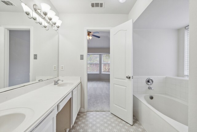 bathroom with a bathing tub, ceiling fan, and vanity