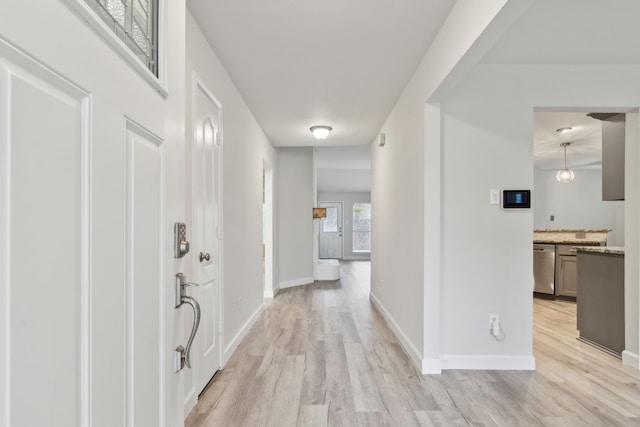 hallway with light hardwood / wood-style flooring