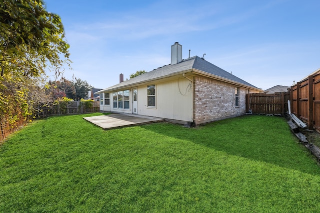 back of property featuring a lawn and a patio area