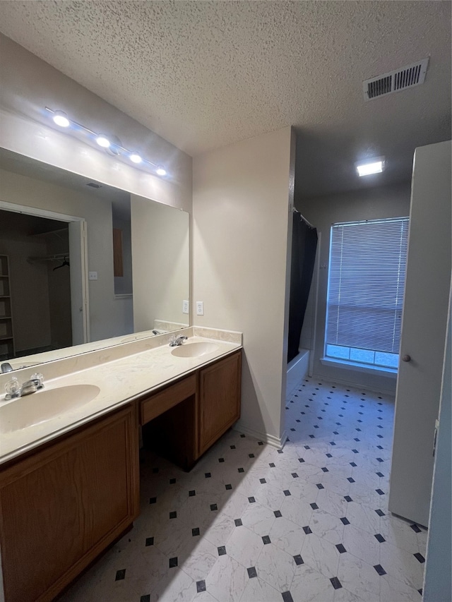 bathroom with vanity and a textured ceiling