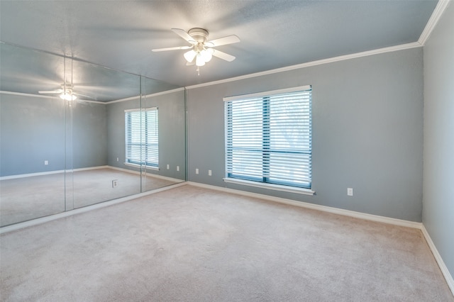 unfurnished bedroom with carpet, ceiling fan, and ornamental molding