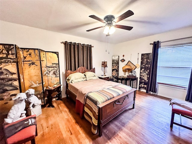 bedroom with hardwood / wood-style floors and ceiling fan